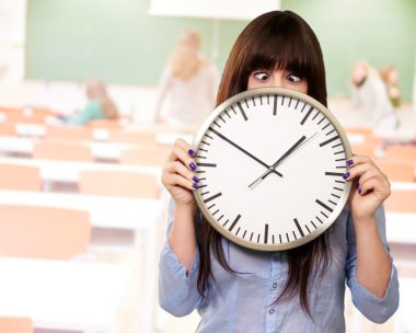 Woman Holding Clock With Squinted Eyes clipart