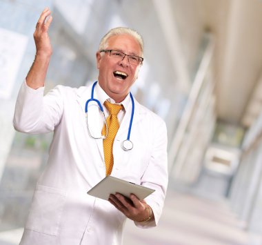Doctor Holding A Tablet And Happy clipart