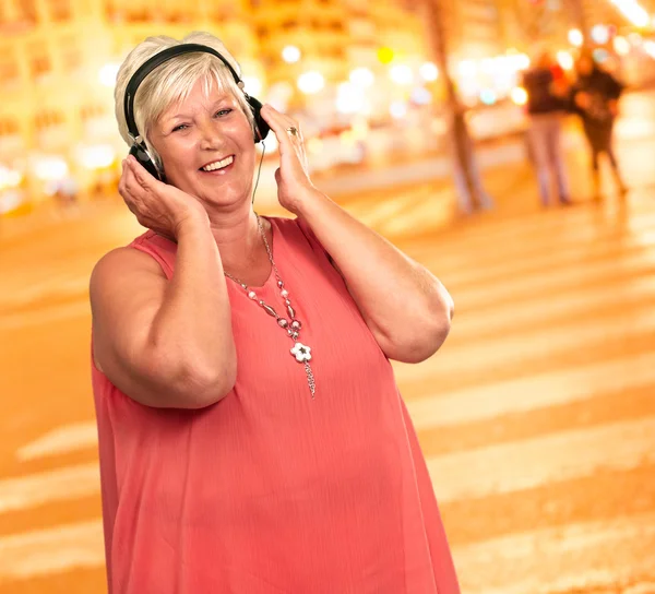 Portrét starší ženy s sluchátka — Stock fotografie
