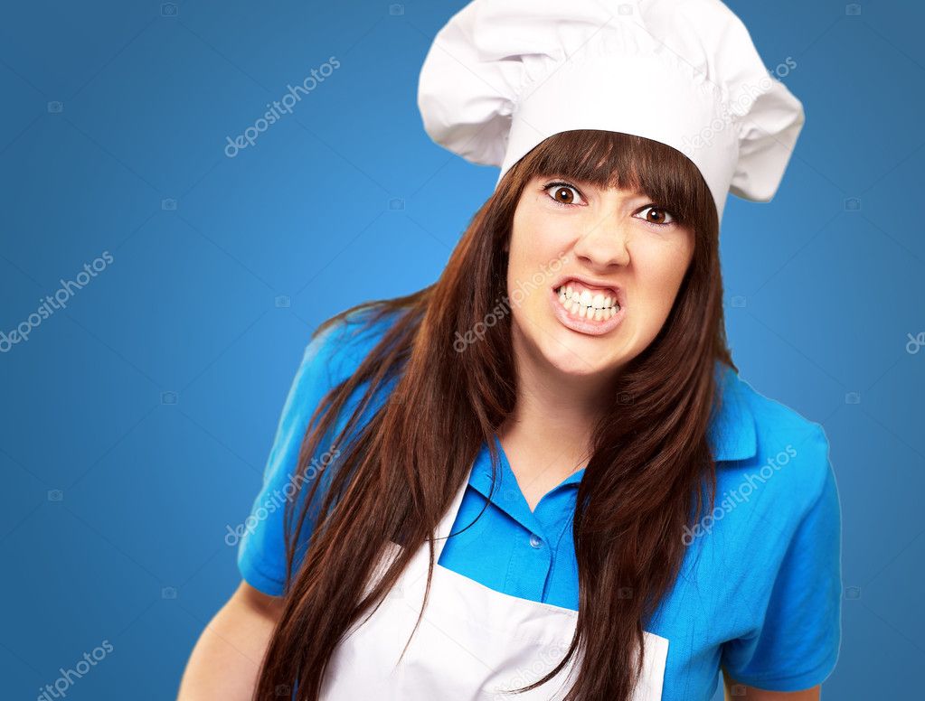 Portrait of a female chef clenching