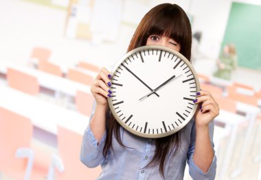 Woman Holding Clock Winking clipart
