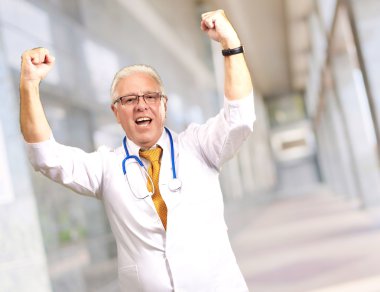 Senior Male Doctor In A Winning Gesture 