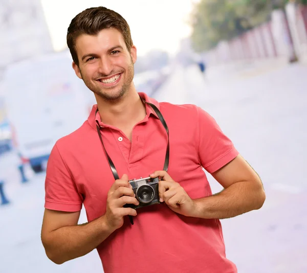 Portrait of a man holding camera — Stock Photo, Image
