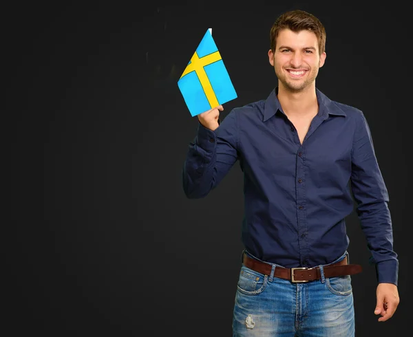 Portrait of a man holding flag — Stock Photo, Image
