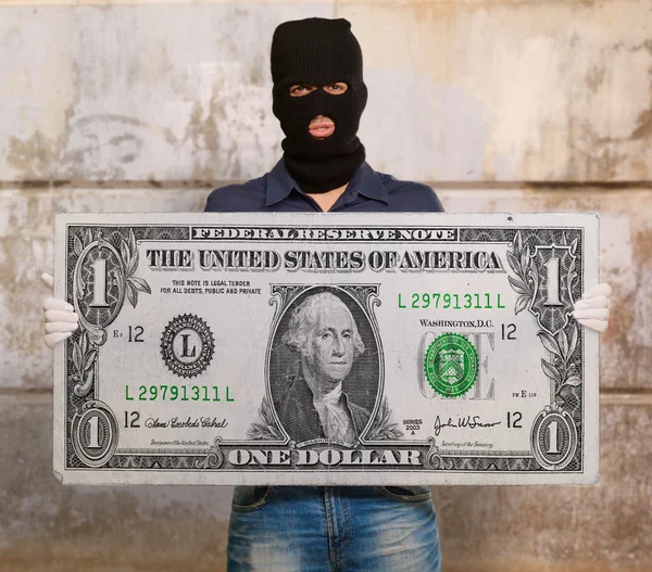 Man wearing mask holding american note — Stock Photo, Image