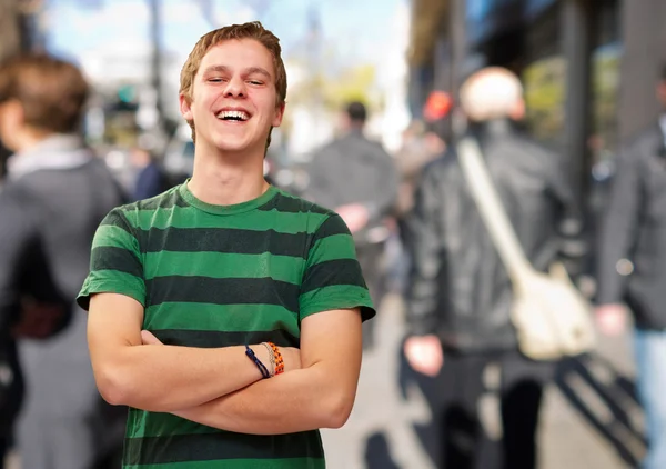 Portrait of young man smiling at city — Stock Photo, Image