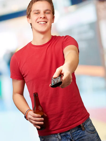 Portrait of a young man with remote control — Stock Photo, Image