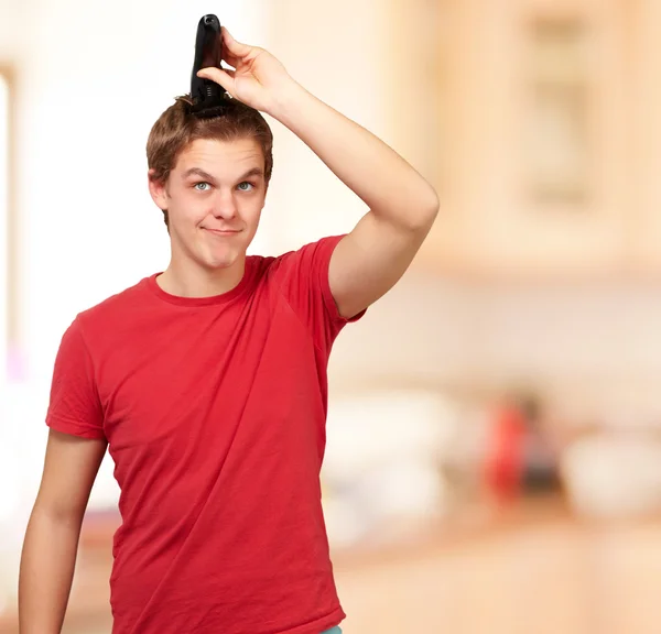 Porträt eines jungen Mannes, der sich drinnen die Haare schneidet — Stockfoto
