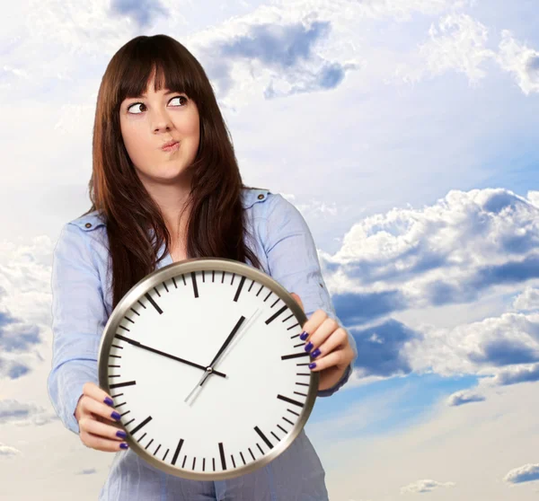 A Young Girl Holding A Clock And Making Face — Stock Photo, Image