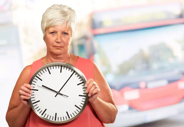 Senior kvinna som håller en klocka — Stockfoto
