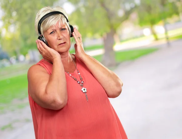 Portret van een senior vrouw met hoofdtelefoon — Stockfoto