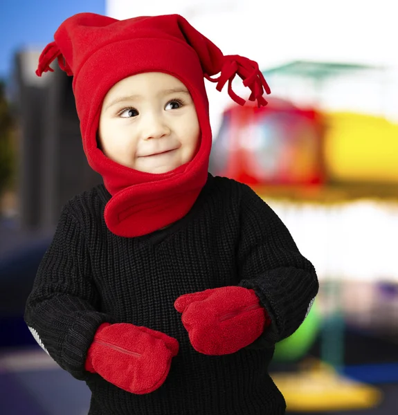 Portrait of an adorable kid smiling wearing winter clothes again — Stock Photo, Image