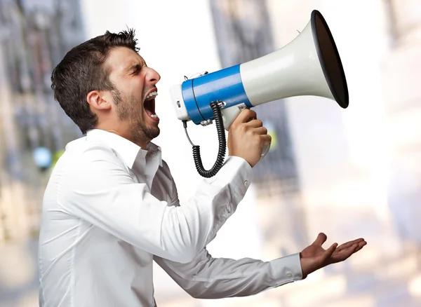 Portrait Of A Man Yelling Into A Megaphone Stock Photo