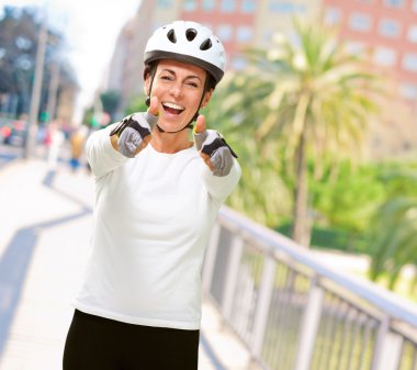 Woman Wearing Helmet Showing Both Thumbs Up clipart