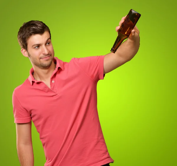 Portrait Of Young Man Holding Empty Bottle — Stock Photo, Image
