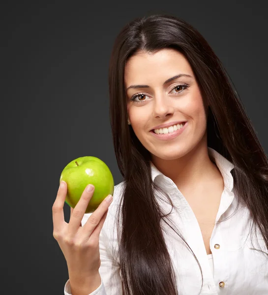 Жінка показує зелене яблуко — стокове фото