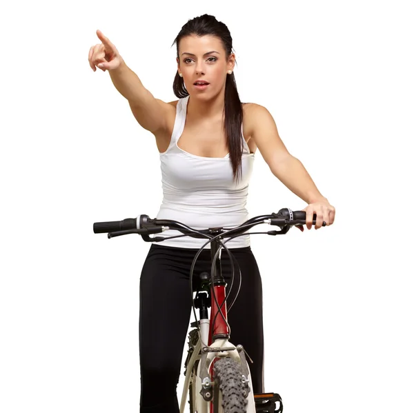 Young girl sitting on bicycle pointing — Stock Photo, Image