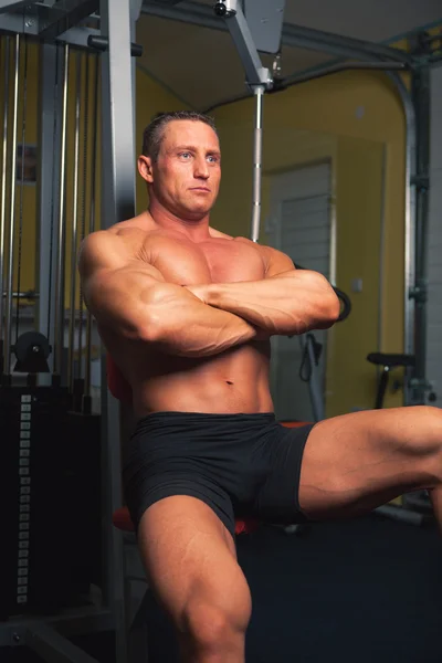 Bodybuilder sits in training room — Stock Photo, Image