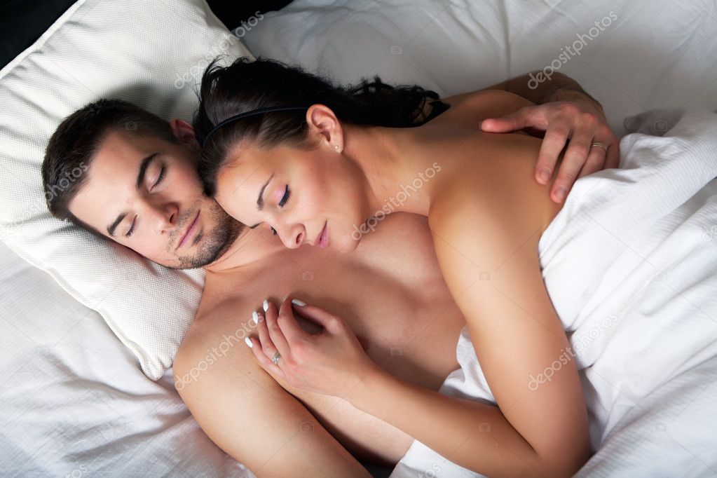 Young romantic couple sleeping in a bed