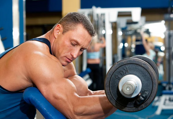Homem com equipamento de musculação no clube desportivo — Fotografia de Stock