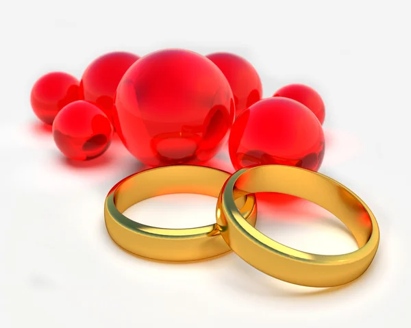 Dva zlaté prsteny a červené koule — Stock fotografie