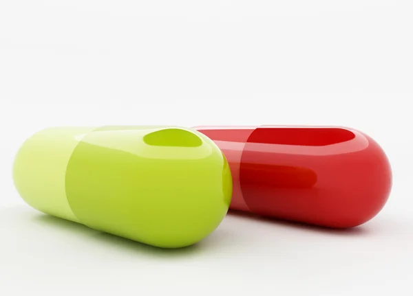 Groene en rode capsule — Stockfoto