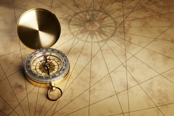 Compass on the old paper background — Stock Photo, Image