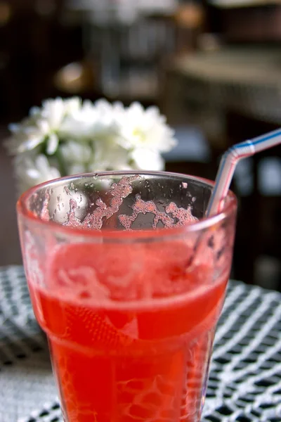 Red alcohol cocktail with flowers — Stock Photo, Image