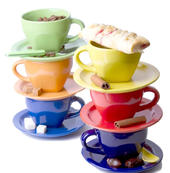 stock image Colored cups with pastry, cinnamon sticks, coffee beans