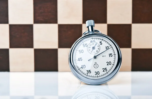 Stopwatch and chessboard — Stock Photo, Image