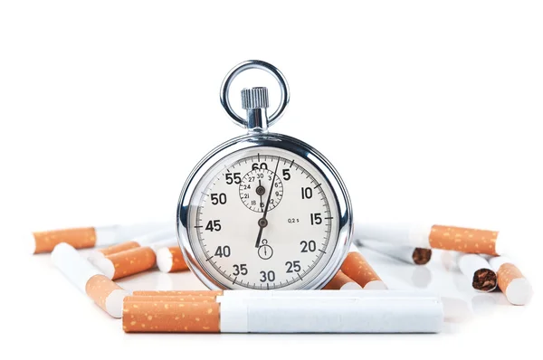 Cigarettes and stopwatch — Stock Photo, Image