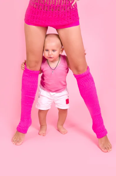 Muchacho de pie entre las piernas de su madre —  Fotos de Stock