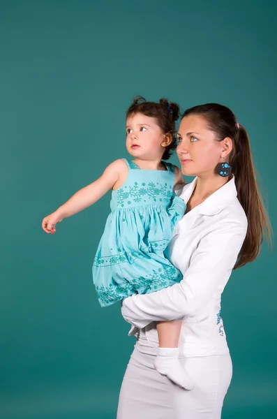 Porträt von Mutter und Tochter auf türkisfarbenem Hintergrund — Stockfoto
