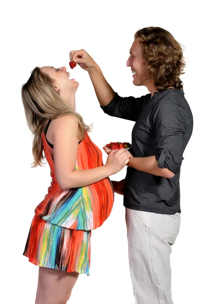 Husband feeds his pregnant wife, strawberries — Stock Photo, Image
