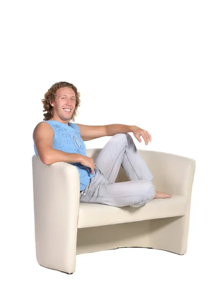 Мужчина сидит на белом диване — стоковое фото