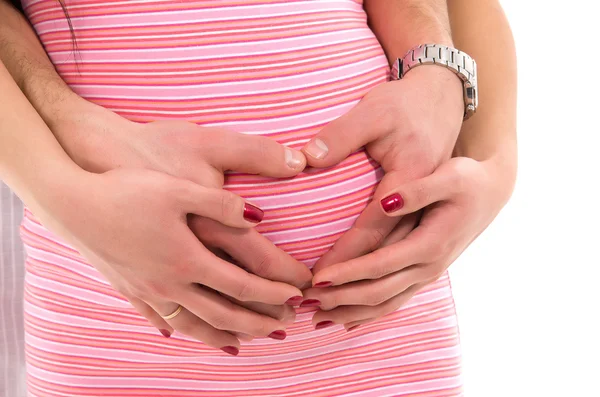 Embarazo humano, las manos dobladas corazón —  Fotos de Stock