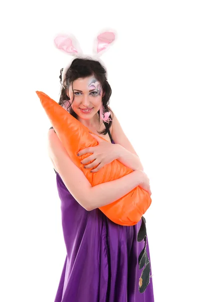 Girl in a silk dress, with a rabbit ears and carrot in hand — Stock Photo, Image