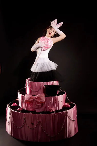 Pin-up girl jumping toy cake — Stock Photo, Image