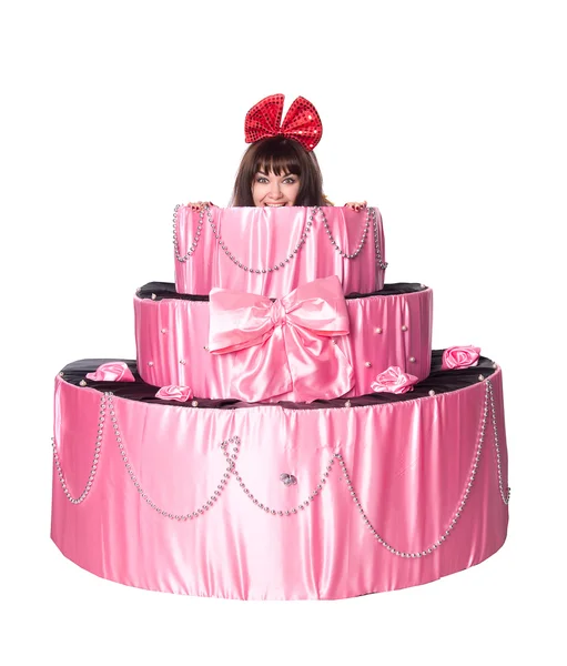 Girl, a surprise gift, looks out a toy cake — Stock Photo, Image