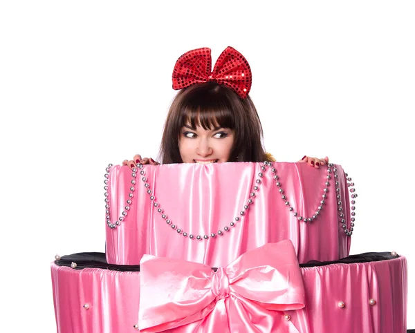 Girl, a surprise gift, looks out a toy cake — Stock Photo, Image