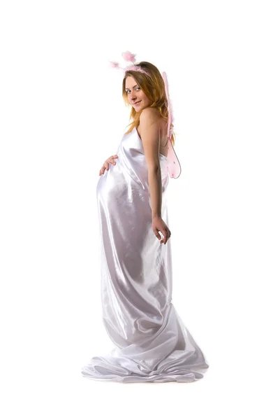 Pregnant woman dressed white satin fabric — Stock Photo, Image