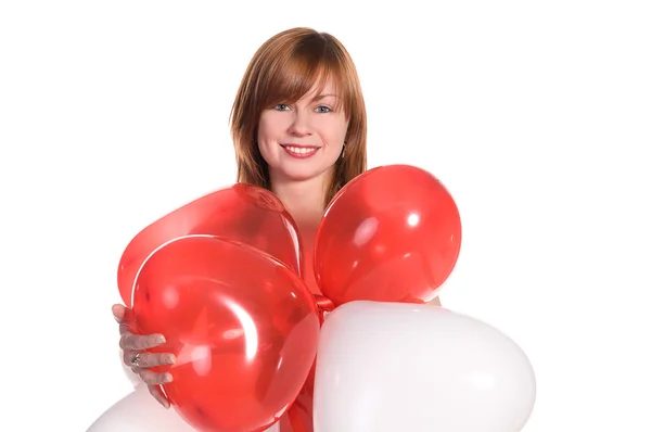 Menina de cabelos vermelhos em um vestido rosa com balões — Fotografia de Stock
