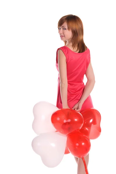 Рудоволоса дівчина в рожевій сукні з повітряними кулями — стокове фото