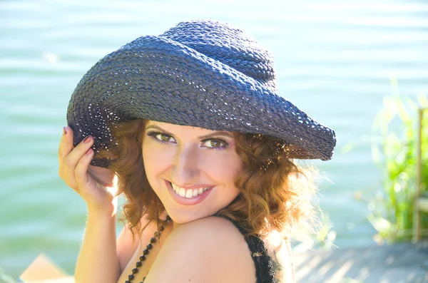 stock image Girl with curly hair in a purple hat