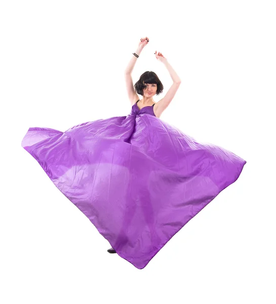 Graceful girl in flying purple silk fabric — Stock Photo, Image