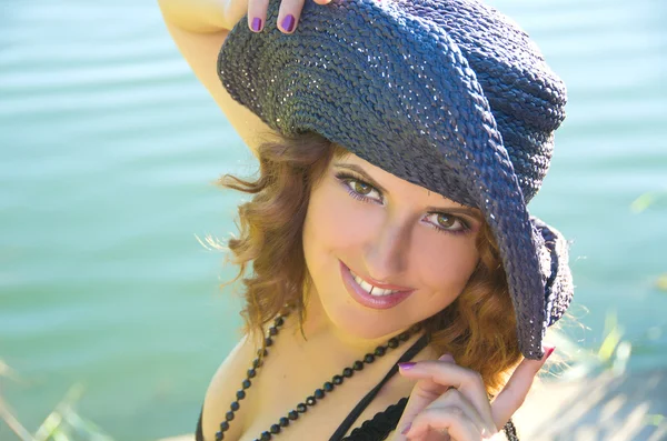 Girl with curly hair in a purple hat — Stock Photo, Image