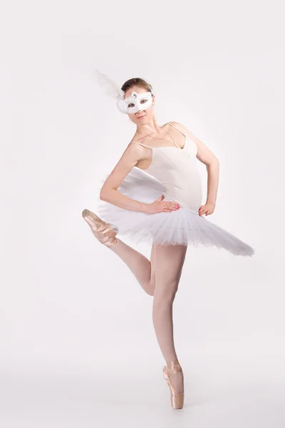 Ballet dancer in a white tutu and a carnival mask — Stock Photo, Image
