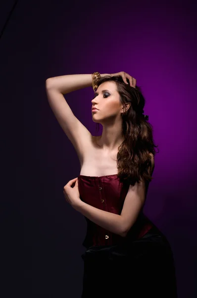 Sexy brunette girl with burgundy corset — Stock Photo, Image