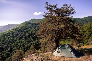 Tourist tent in the wild mountains of Ukraine clipart