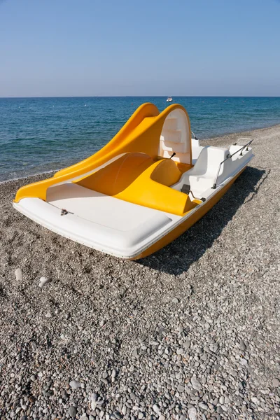 Yellow catamaran on a beach — Stock Photo, Image